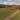 Person motorcycling on a long road with fields and mountains in the Catskills