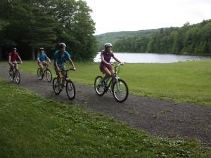 family biking on a path at North South Lake