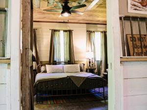 Rustic bedroom with ceiling fan at the Long Neck Inn