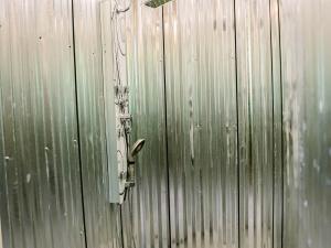 Shower stall with metal walls in a guestroom bathroom at the Long Neck Inn