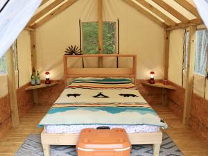 Bed inside of a glamping tent at Treetopia