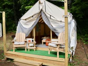 Outside of the canvas glamping tent with deck at Treetopia