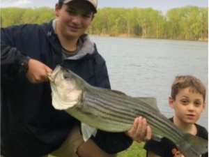 two boys with fish