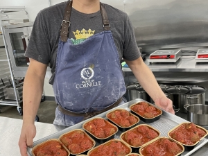 Owner, Steve, holding fresh tray of meatballs 