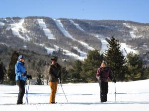 Skiiers with Windham Mountain in background