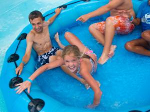 Zoom Flume Water Park family on raft in the water