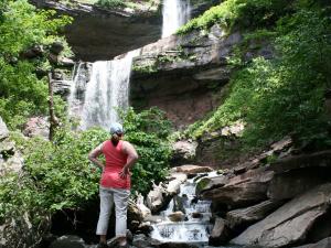 woman looking up at Kaaterskill Falls in Summer