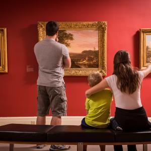 family looking at art in a museum