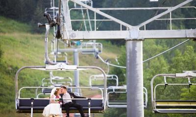 Bride and groom on a chair lift at a catskills ski resort in summer