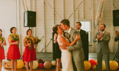 couple kissing with friends around