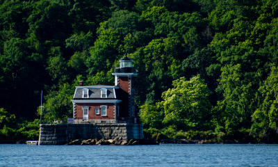 Athens-lighthouse-set-against-green-trees-film-in-greene-locations