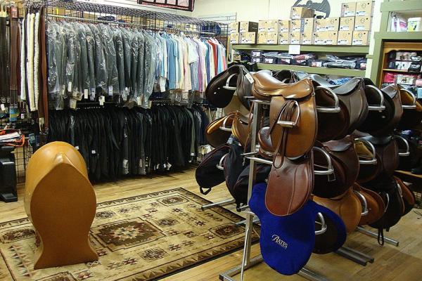 Greene County Horseshoe Supply, Inc. interior with saddles and clothing for sale