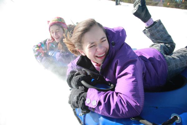 2 kids tubing in winter at Windham Mountain Adventure Park Snowtubing