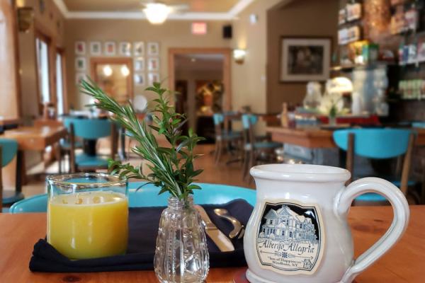 &Breakfast by Albergo orange juice and mug on table