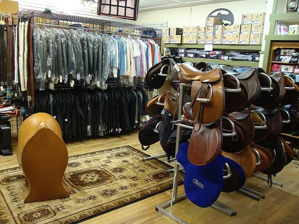 Greene County Horseshoe Supply, Inc. interior with saddles and clothing for sale