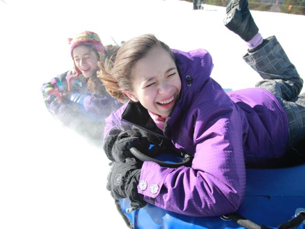 2 kids tubing in winter at Windham Mountain Adventure Park Snowtubing