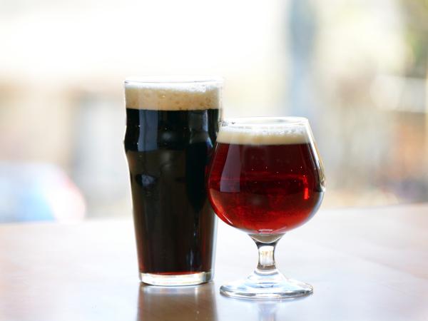 Two Beer Glasses full of dark beer at a bar in the catskills