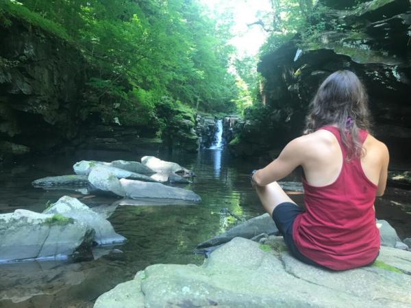 A girl sitting on rock at Purling waters 