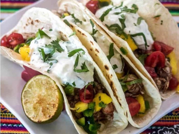 soft tacos with lime, sour cream, mango, and cilantro