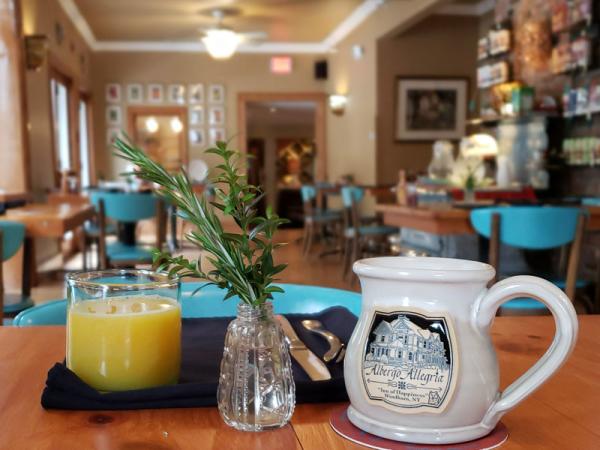 &Breakfast by Albergo orange juice and mug on table