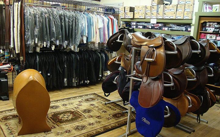 Greene County Horseshoe Supply, Inc. interior with saddles and clothing for sale