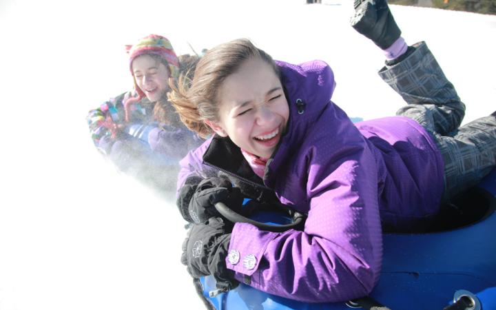 2 kids tubing in winter at Windham Mountain Adventure Park Snowtubing