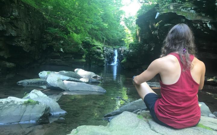 A girl sitting on rock at Purling waters 