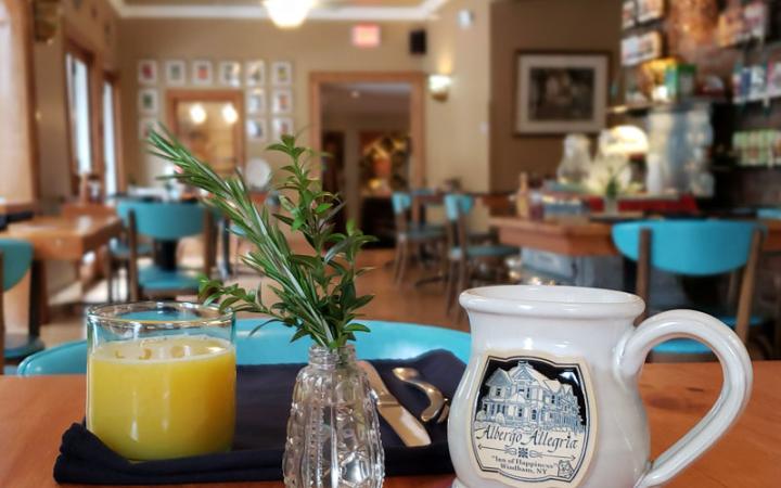 &Breakfast by Albergo orange juice and mug on table